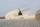 helicopter landing in cloud of dust on desert